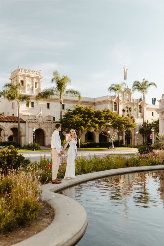 Warm, glowing light during a Golden Hour Engagement at Balboa Park highlights the couple’s connection